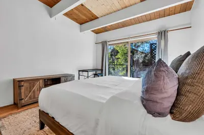 a bedroom with a white bed with pillows and a window at Peaceful Forest Retreat Near Lake and Town in Tahoe City