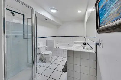 a bathroom with a toilet and a tub and a sink at Peaceful Forest Retreat Near Lake and Town in Tahoe City