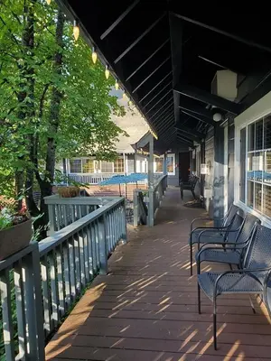 a covered walkway with benches on a building at Timberline Lodge - Arnold - Bear Valley - Murphys in Arnold