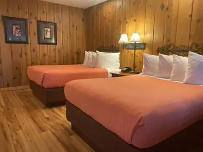 a hotel room with two beds and wooden walls at Timberline Lodge - Arnold - Bear Valley - Murphys in Arnold