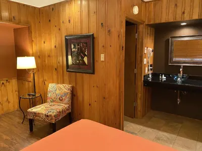 a room with wooden walls and a chair and a table at Timberline Lodge - Arnold - Bear Valley - Murphys in Arnold