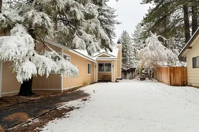 a house with a driveway covered in snow at Golden Pine Lodge in South Lake Tahoe