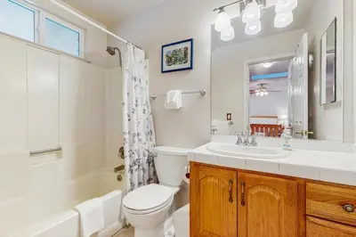a bathroom with a toilet and a sink and a tub at Golden Pine Lodge in South Lake Tahoe