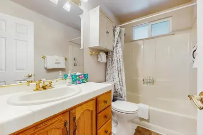 a white bathroom with a sink and a toilet at Golden Pine Lodge in South Lake Tahoe