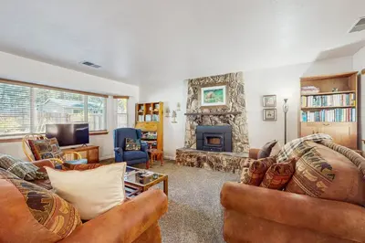 a living room with two couches and a fireplace at Golden Pine Lodge in South Lake Tahoe
