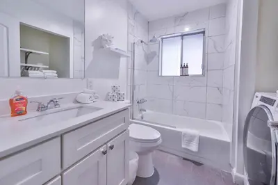 a white bathroom with a sink and a toilet at Iroquois Ridge Hot Tub Near Lake Tahoe & Skiing in South Lake Tahoe