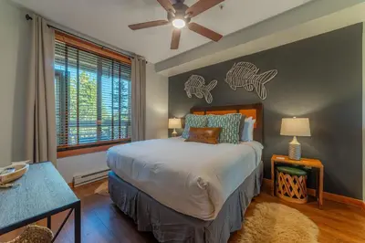 a bedroom with a bed and a large window at Posh Village 2/2; Ski-In/Out + Premiere Perks! in Mammoth Lakes