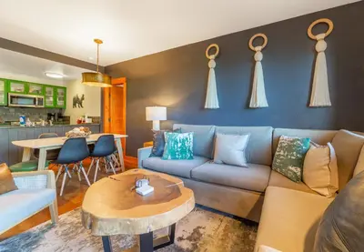 a living room with a couch and a table at Posh Village 2/2; Ski-In/Out + Premiere Perks! in Mammoth Lakes