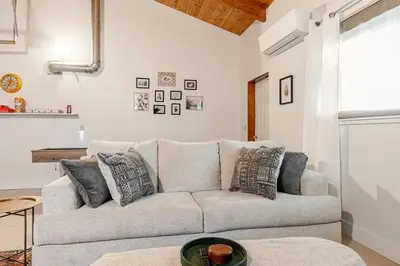 a living room with a couch and a table at NEW LISTING, Near Yosemite South Gate entrance and town, King bed, Hot Tub, BBQ, Firepit & Mountain Views in Oakhurst