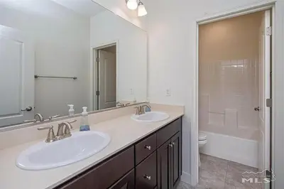 a white bathroom with two sinks and a tub at Peaceful Private Room near Sparks in Sparks