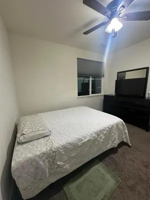 a bedroom with a bed and a ceiling fan at Peaceful Private Room near Sparks in Sparks