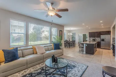 a living room with a couch and a ceiling fan at Nic's Home in Visalia