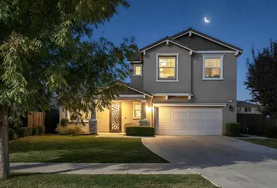 a house with a garage at night at Nic's Home in Visalia