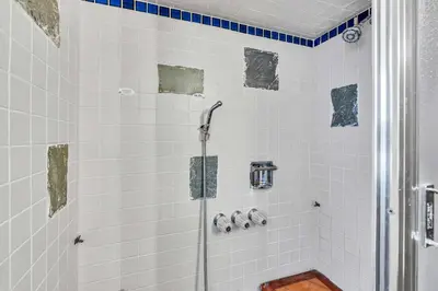 a shower in a bathroom with white tiles at Wooded Getaway Steam Shower plus Hot Tub in Tahoe City