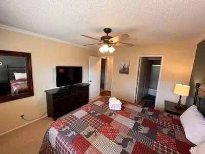 a bedroom with a bed and a flat screen tv at Cozy Walk-to-Lifts Mammoth Condo with Hot Tub in Mammoth Lakes