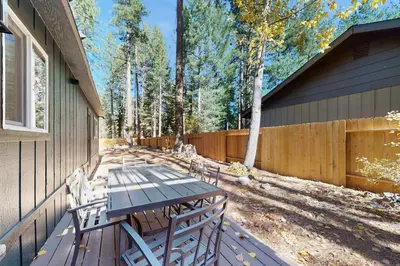 a picnic table on the side of a house at The Pine Chalet in South Lake Tahoe