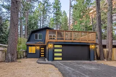 a house with a deck on top of a garage at The Pine Chalet in South Lake Tahoe