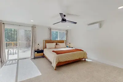 a bedroom with a bed and a ceiling fan at The Pine Chalet in South Lake Tahoe
