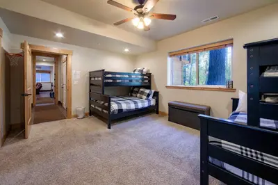 a bedroom with a bunk bed and a ceiling fan at The T-Pot Chalet for 12 in South Lake Tahoe