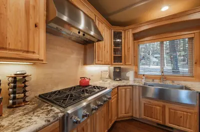 a kitchen with a stove and a sink at The T-Pot Chalet for 12 in South Lake Tahoe