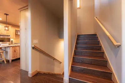 a staircase in a house with a kitchen at The T-Pot Chalet for 12 in South Lake Tahoe