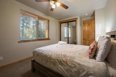 a bedroom with a bed and a ceiling fan at The T-Pot Chalet for 12 in South Lake Tahoe
