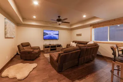 a living room with two couches and a flat screen tv at The T-Pot Chalet for 12 in South Lake Tahoe