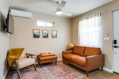 a living room with a couch and two chairs at Couples Retreat! Shop, Dine, Explore Dtwn Oakdale in Oakdale