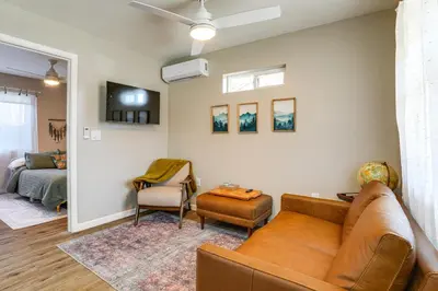 a living room with a couch and a bed at Couples Retreat! Shop, Dine, Explore Dtwn Oakdale in Oakdale