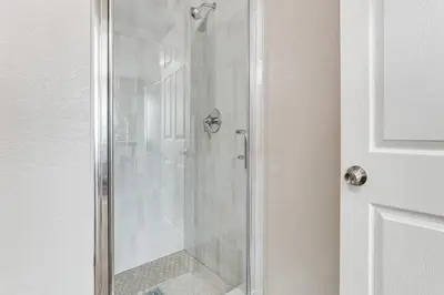 a shower with a glass door in a bathroom at Couples Retreat! Shop, Dine, Explore Dtwn Oakdale in Oakdale