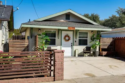 a house with a fence in front of it at Couples Retreat! Shop, Dine, Explore Dtwn Oakdale in Oakdale