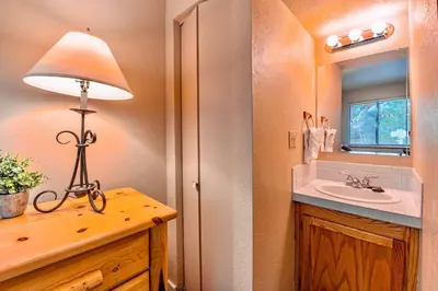 a bathroom with a sink and a lamp on a counter at Galaxy Way Close to Stagecoach Chair in Stateline