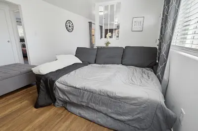 a bedroom with a large bed in a room at The Cozy Rustic Sequoia Wi-Fi & 2 Garage in Tulare