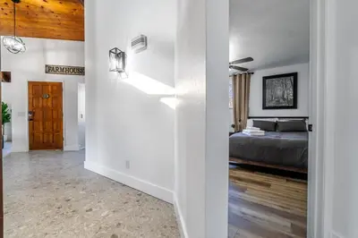 a room with a bed and a bedroom with white walls at OctaFarmRetreat - Gateway To Sequoia Natl Park in Visalia