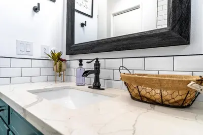 a bathroom with a sink and a mirror at OctaFarmRetreat - Gateway To Sequoia Natl Park in Visalia