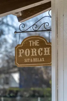 a sign that reads the porch sit and relax at OctaFarmRetreat - Gateway To Sequoia Natl Park in Visalia