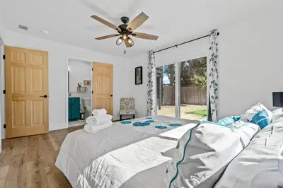 a bedroom with a bed and a ceiling fan at Cambridge Corner - Gateway to Sequoia Ntl Park in Visalia