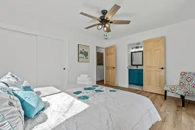 a bedroom with a bed and a ceiling fan at Cambridge Corner - Gateway to Sequoia Ntl Park in Visalia
