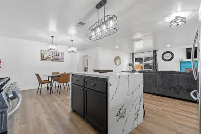 a kitchen and living room with a table and a couch at Cambridge Corner - Gateway to Sequoia Ntl Park in Visalia