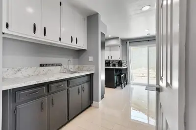 a kitchen with white cabinets and a counter top at The Royal Oak Splash Sequoia Nat'l Park Lake Mts in Visalia