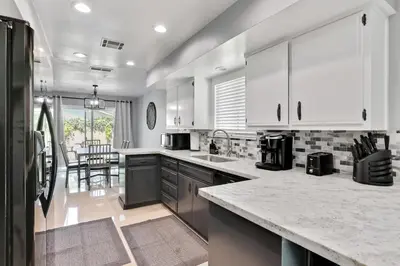 a kitchen with white cabinets and a counter top at The Royal Oak Splash Sequoia Nat'l Park Lake Mts in Visalia