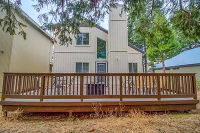a wooden deck in front of a house at Halonas Cozy Cabin 2M To Lake in Shaver Lake