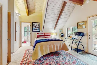 a bedroom with a bed and a table in a room at Dog-Friendly Retreat with Lake Views in Kings Beach in Kings Beach