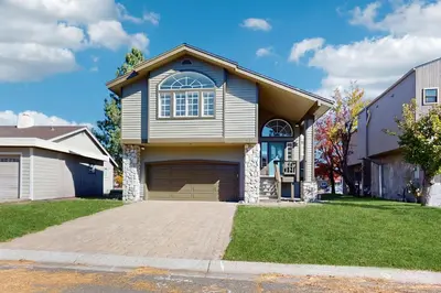 a house with a large garage in a yard at Waterfront Bliss in South Lake Tahoe
