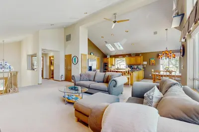 a large living room with couches and a table at Waterfront Bliss in South Lake Tahoe