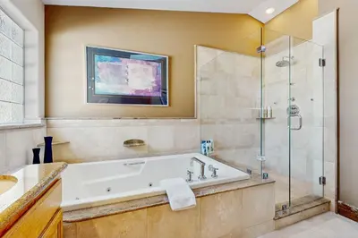 a bathroom with a tub and a glass shower at Waterfront Bliss in South Lake Tahoe