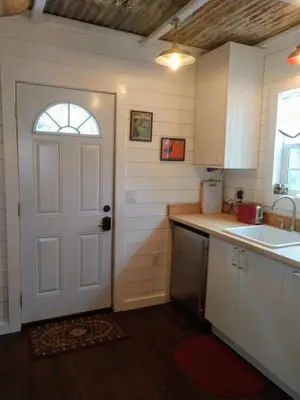 a kitchen with a white door and a sink at Meadow Creek Cabin in Camino