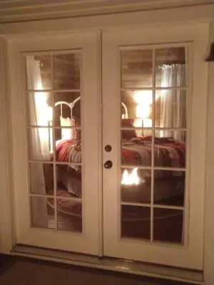 a white cabinet with glass doors in a room at Meadow Creek Cabin in Camino