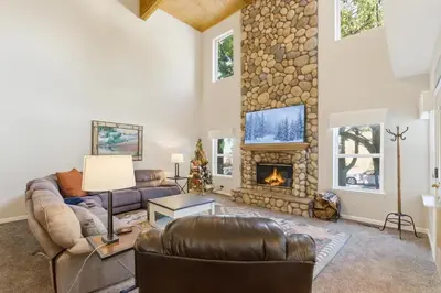 a living room with a couch and a fireplace at The Trailhead Hot Tub, Hikes & Night Skies in Shaver Lake