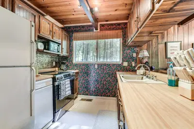 a kitchen with a refrigerator and a sink at 4 Mi to State Park Quiet Escape with Deck in Arnold in Arnold